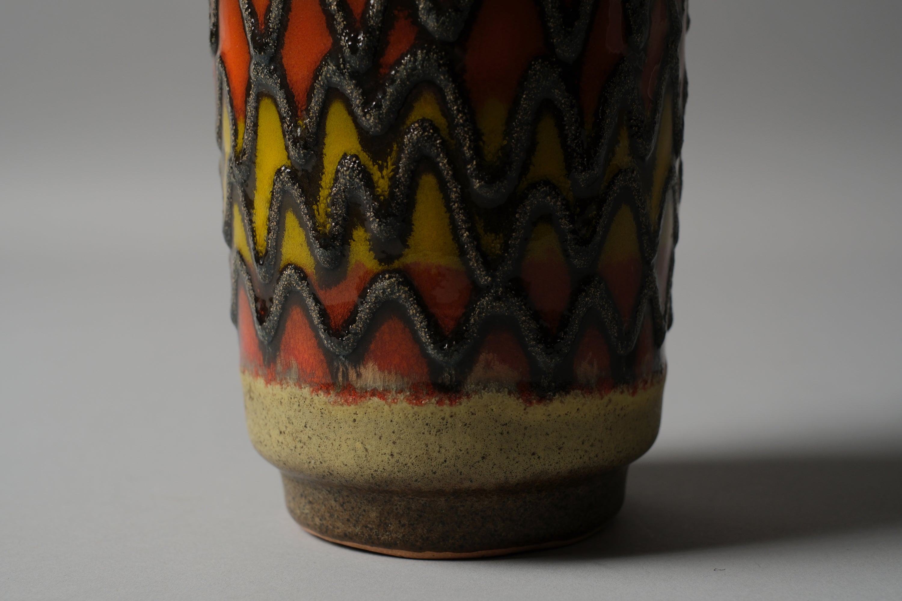 VEB Haldensleben fat lava vase, raised charcoal zigzag ridges over saturated orange and yellow lava glaze ground, 1960s