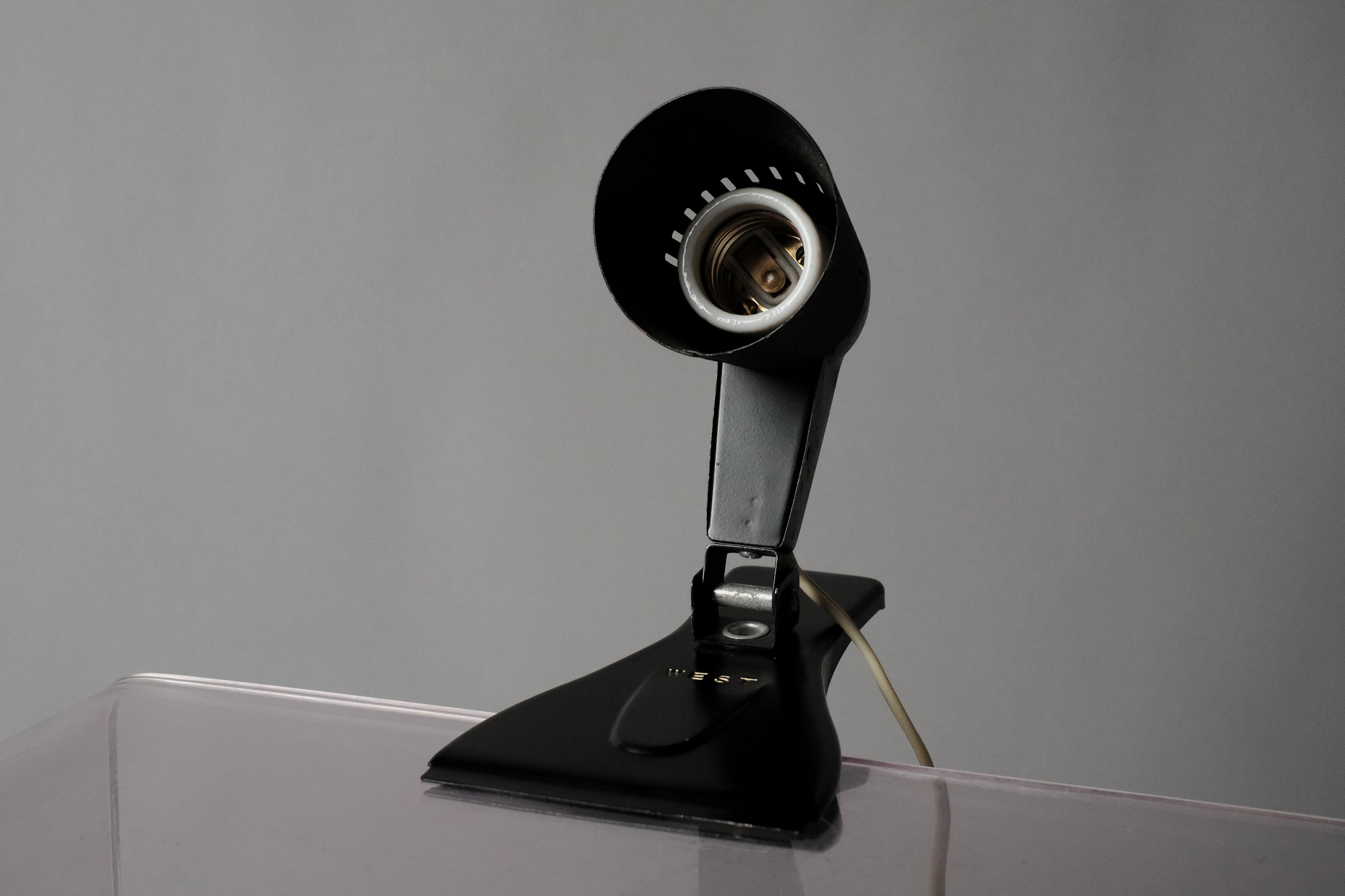 Front view of the E27 bulb socket housing on the vintage 1960s ERCO MCM clamp spotlight German industrial clip-on desk lamp showcasing its functionalist design.