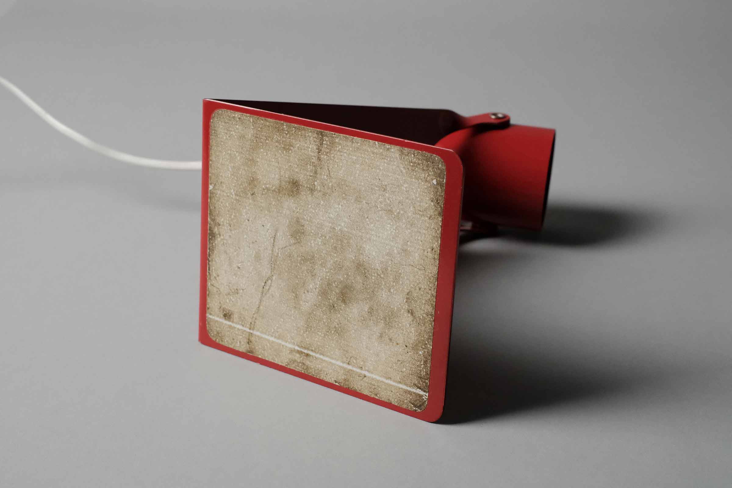 The underside of the vintage 1970s Gnosjo Konstsmide Swedish MCM red metal industrial desk lamp revealing the protective foam padded base.