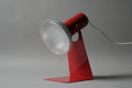 Primary studio shot of the vintage 1970s Gnosjo Konstsmide Swedish MCM red metal industrial desk lamp with its minimalist sculptural base.