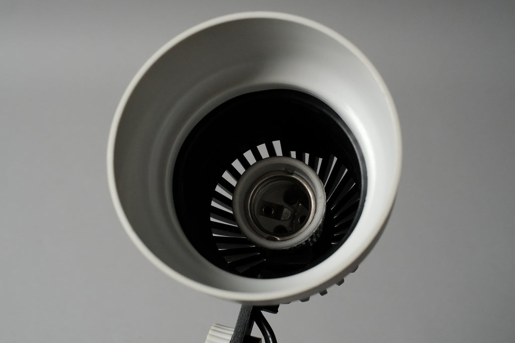 An interior view of the white reflector shade on the vintage 1970s Aro Leuchte modernist adjustable desk lamp revealing the E27 bulb socket fitting.