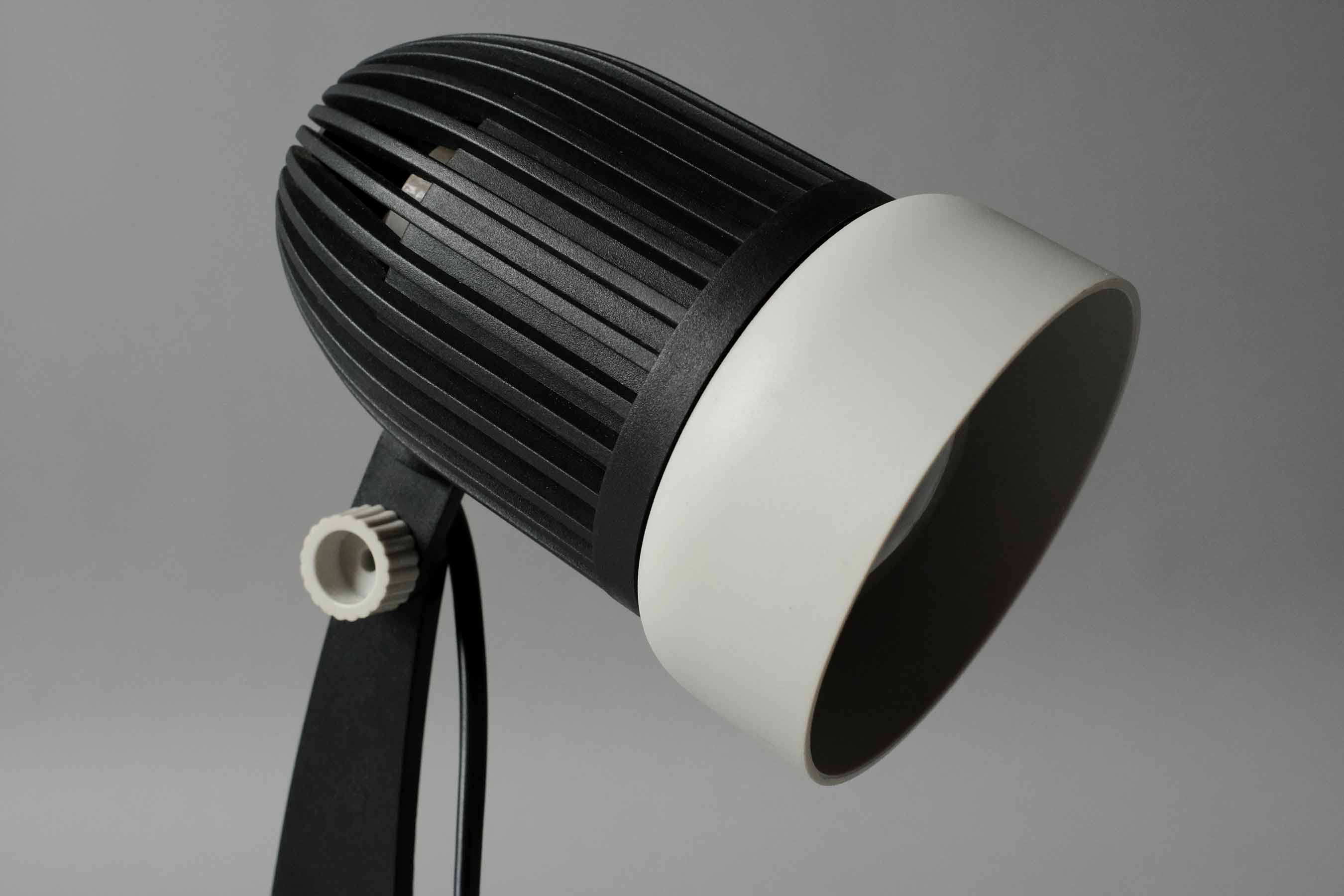 Close-up detail of the ribbed cooling vents on the back of the vintage 1970s Aro Leuchte modernist adjustable desk lamp head.