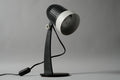 Primary studio profile of the vintage 1970s Aro Leuchte modernist adjustable desk lamp in black and white featuring a ribbed spherical head.