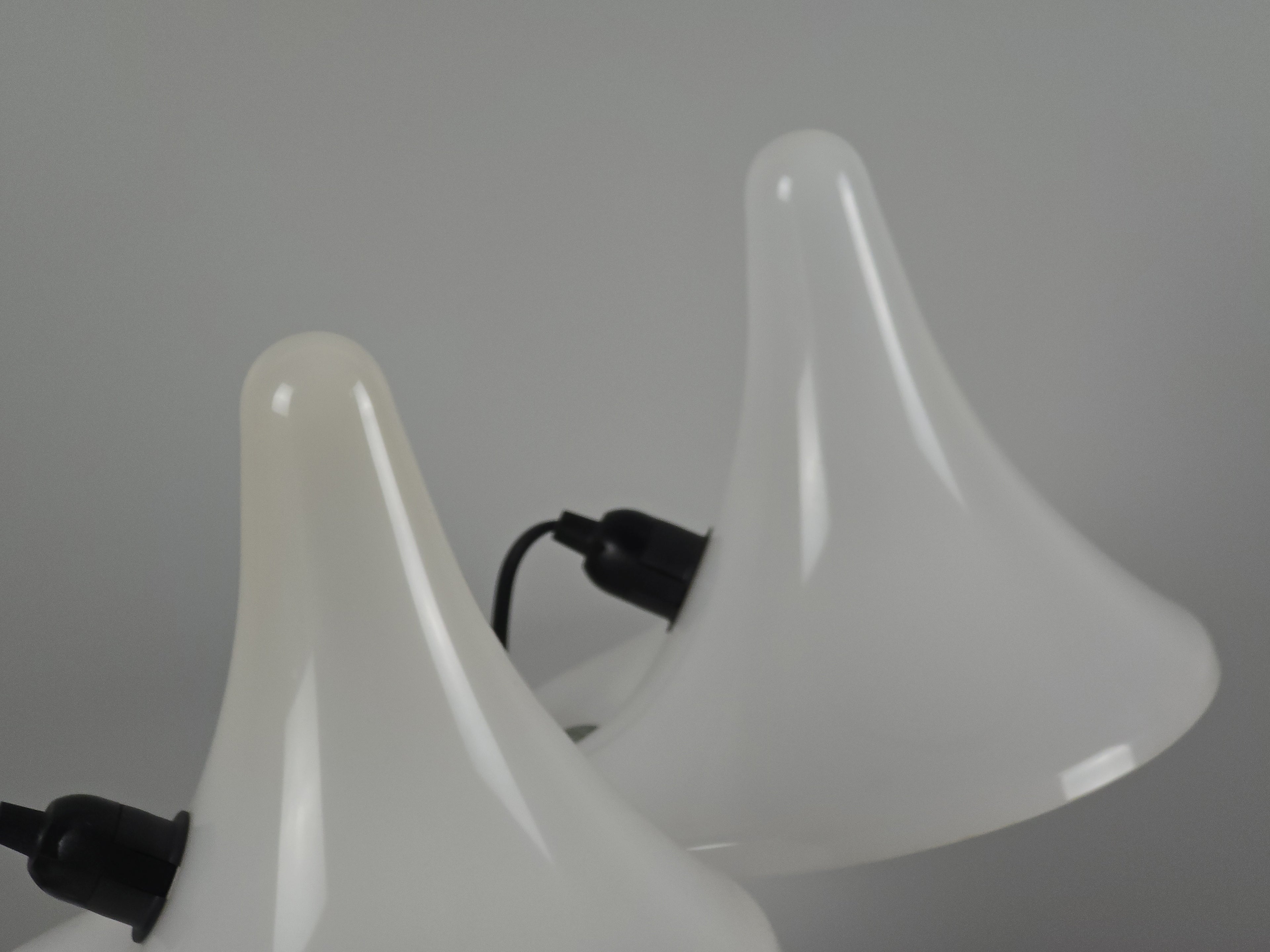 Close-up perspective of the curved shades "fin," highlighting the architectural postmodern lines of the Italian design. Also highlighting a slight yellowing on one of the trumpet shade tops.