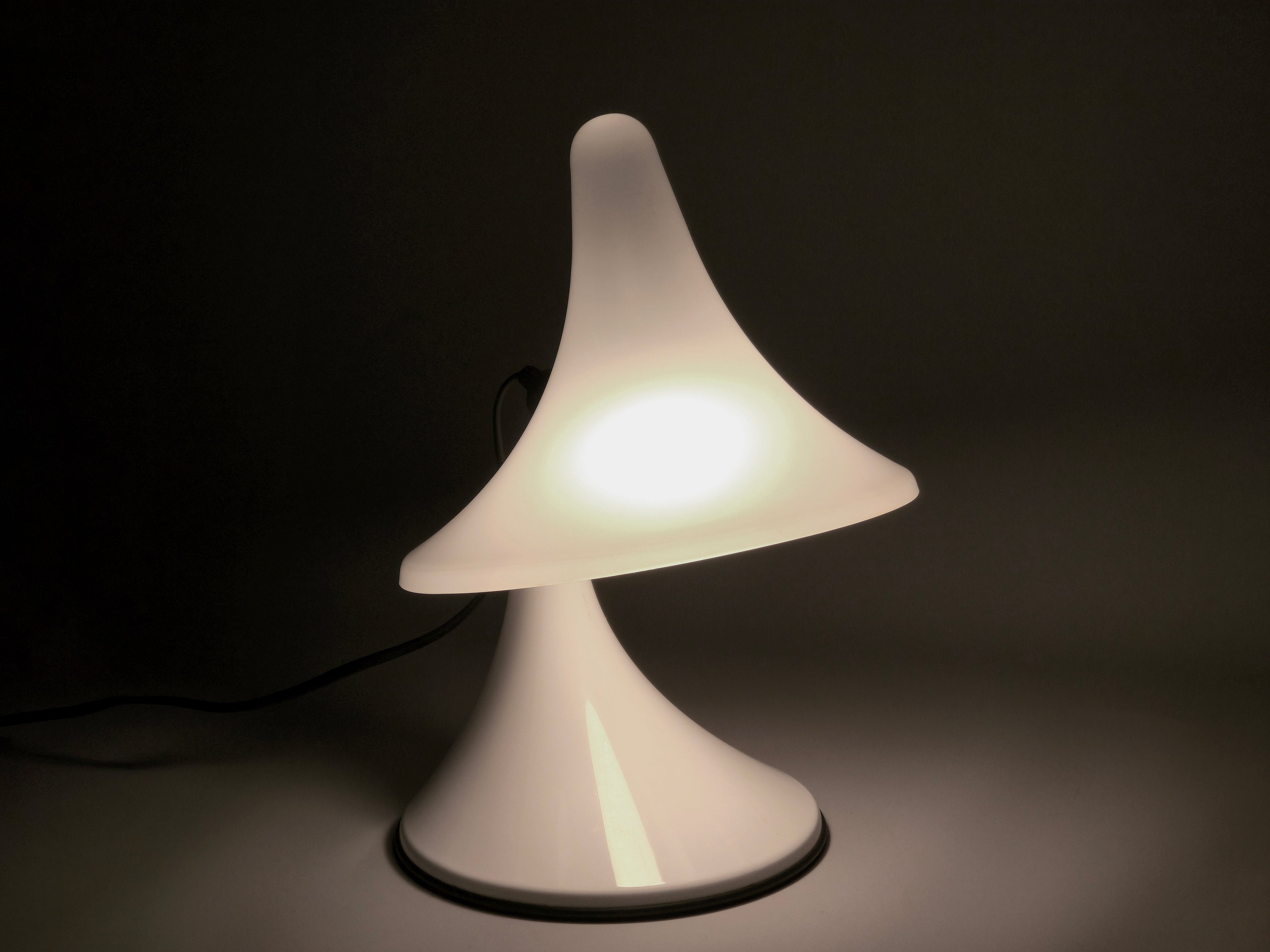 The Karin-M lamp glowing in a dark setting, demonstrating its capability as an ambient mood light.
