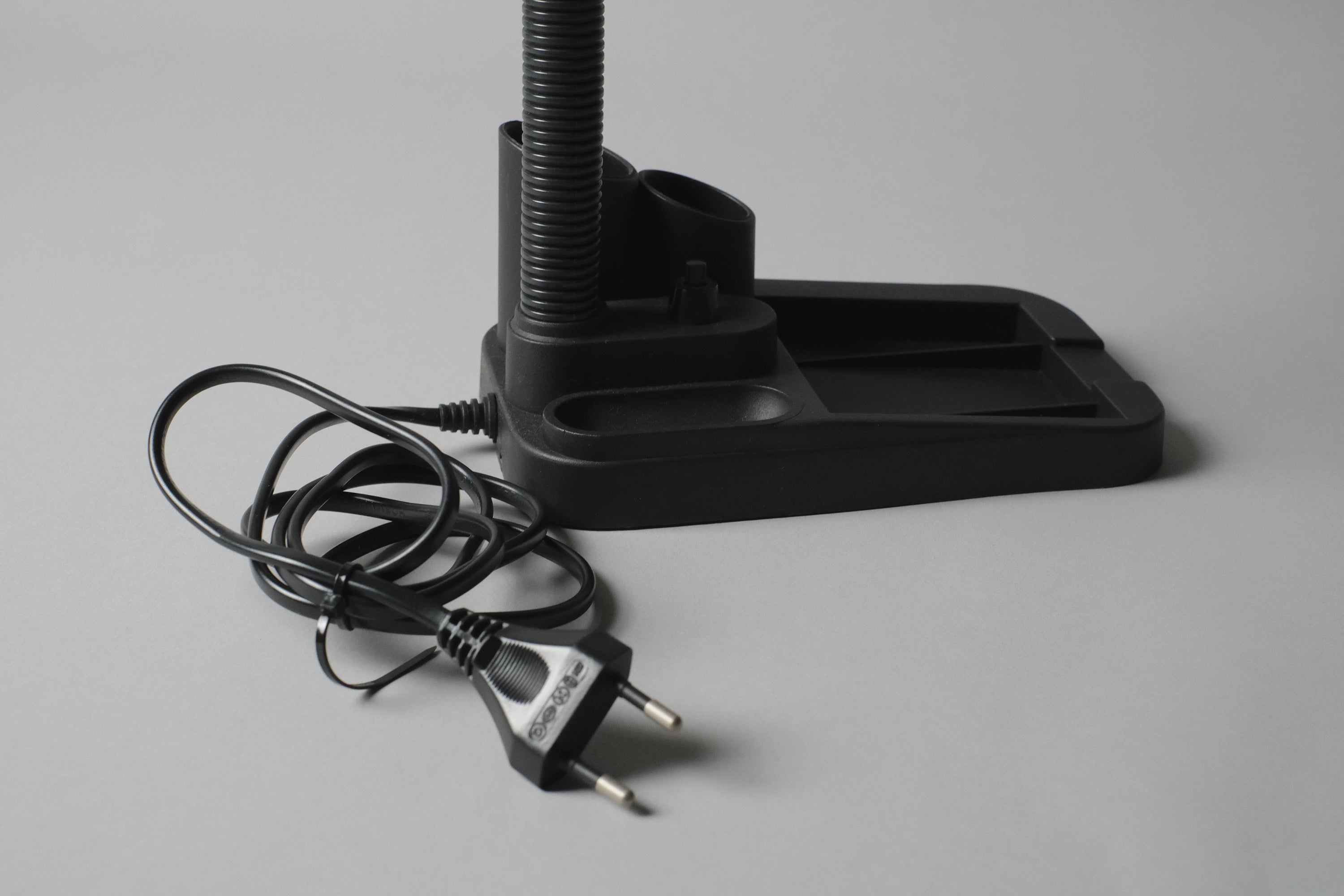 Close-up detail of the built-in stationary caddy, the cord and Euro power plug.