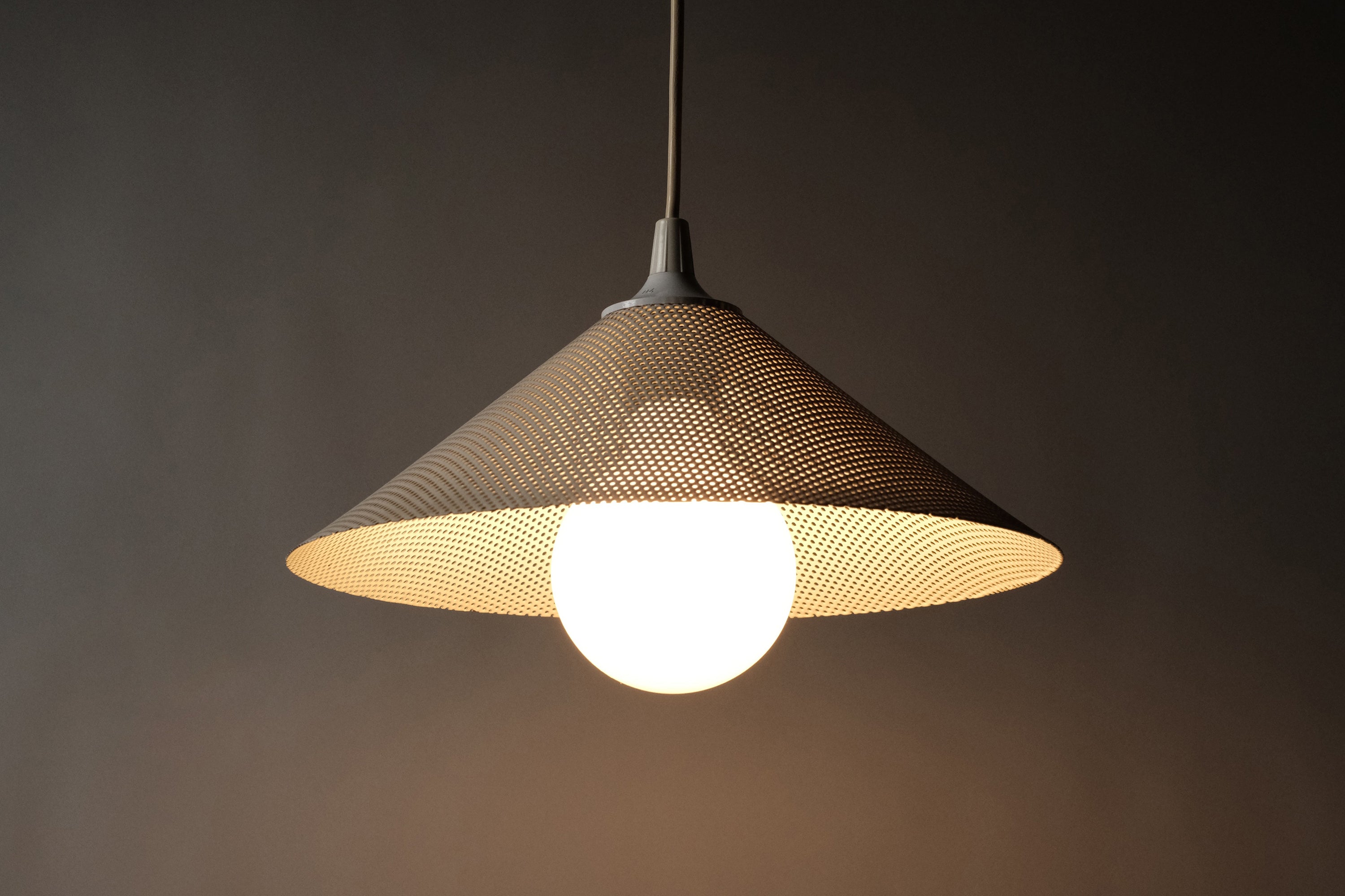 Herda perforated metal conical pendant lamp, 1980s Dutch industrial design, lit, front view