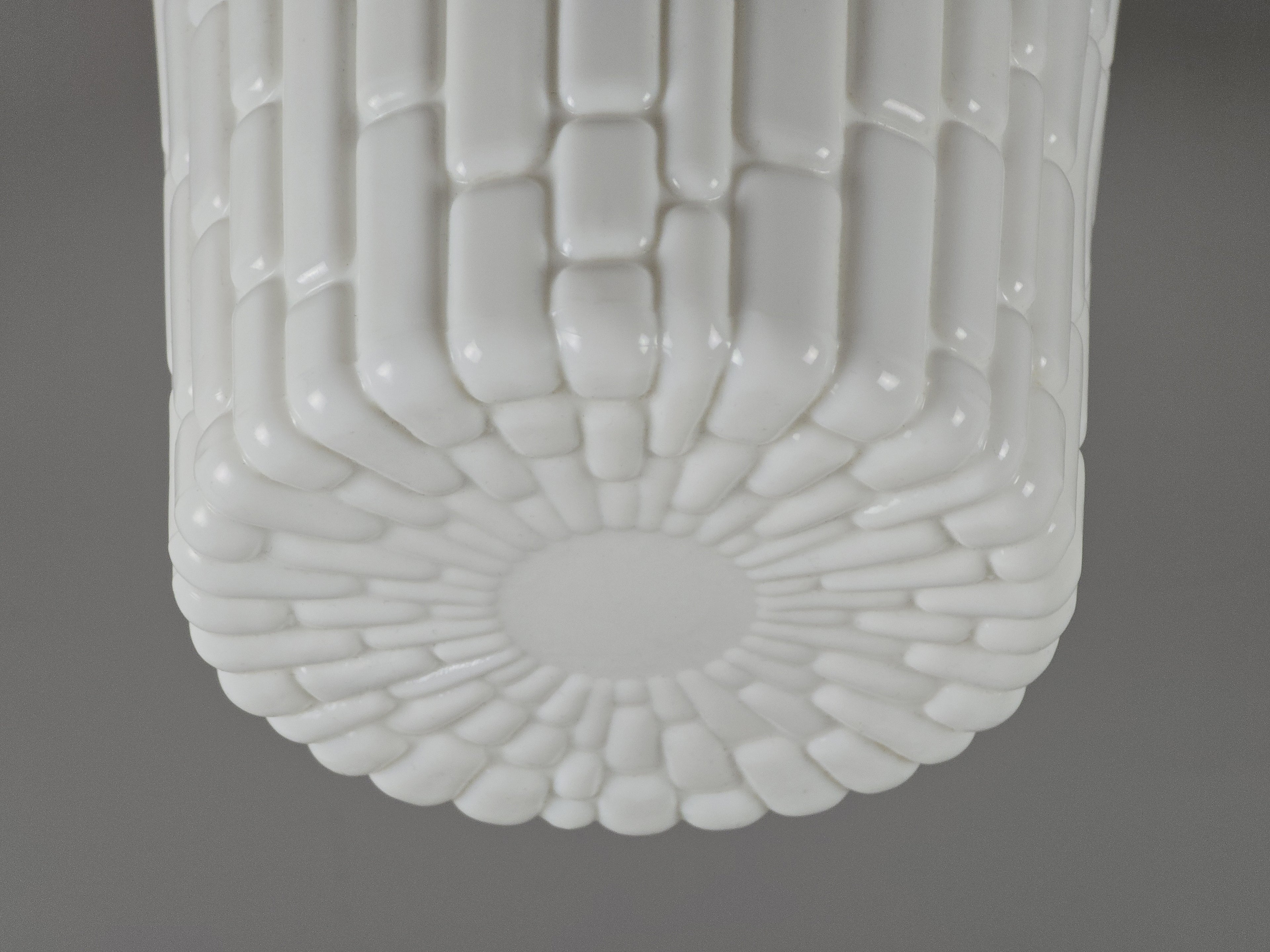 close up image of a vintage light fixture opal glass brick texture design