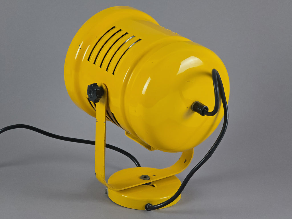 Back side view of 1980s yellow metal industrial wall lamp showing the punchy yellow paint and base with cord details.
