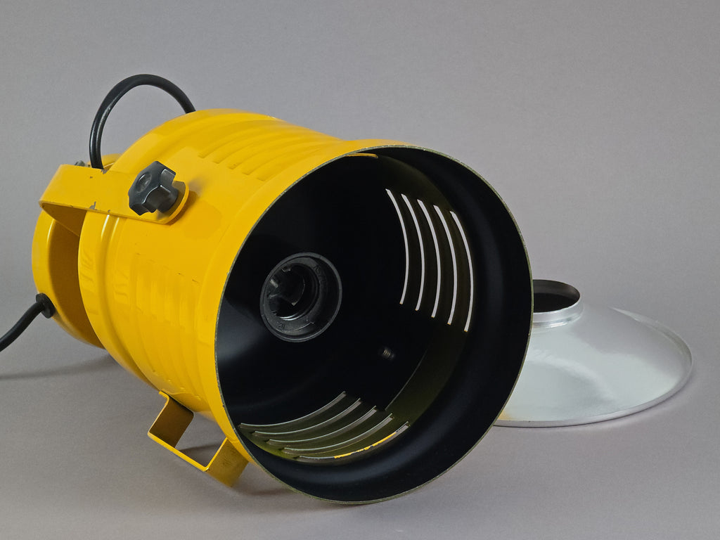 Laid down image of yellow industrial lamp showing the black painted interior of shade with the E27 light bulb fitting.